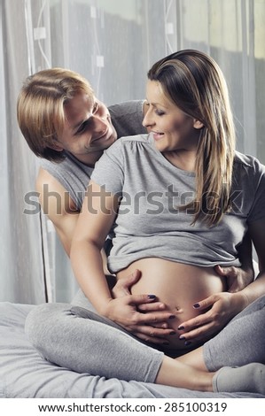 Similar – Pregnant woman embraced by her husband