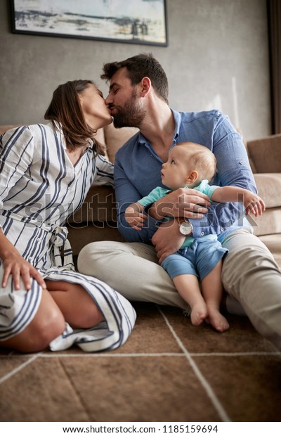 Happy Couple Holding Their Cute Baby Stock Photo Edit Now 1185159694