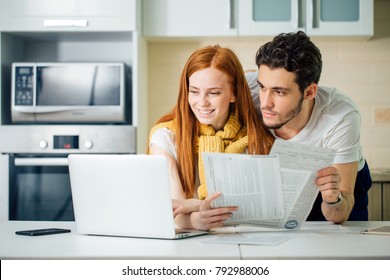 Happy Couple At Home Paying Bills With Laptop And Looking Screen