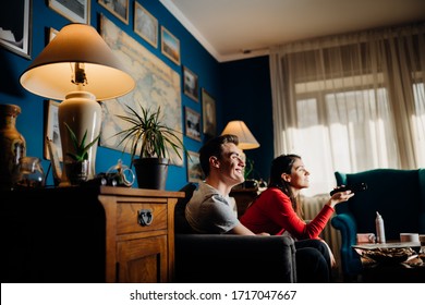 Happy Couple At Home Watching TV Together.Remote Control Fight.Watching Favorite Show/film.Fun Comedy Movie.Binge Watching Television.Relationship Home Quarantine Lockdown Time.Streaming Service