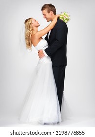 Happy Couple Hug After Wedding Against A Studio Mockup Background With A Smile And Bouquet. Romantic Young Man And Woman Dancing With Fashion, Elegant And Fancy Suit And Dress After Marriage Event