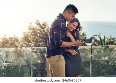 Happy couple, hug and balcony with phone for social media, online browsing or funny post in nature. Young man and woman with smile or embrace on mobile smartphone for outdoor chatting, texting or app - Powered by Shutterstock