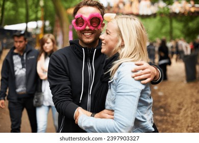 Happy couple, hug and music festival for love, care or support at crowded party, DJ event or fun park. Man and woman smile in embrace, affection or trust for festive outdoor celebration or holiday - Powered by Shutterstock