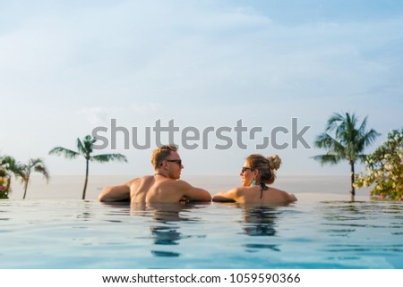 Happy couple in infinity pool