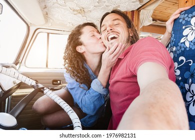 Happy couple inside minivan doing a selfie during road trip in summer vacation - Focus on man face - Powered by Shutterstock