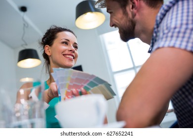 Happy couple interacting with each other in café - Powered by Shutterstock