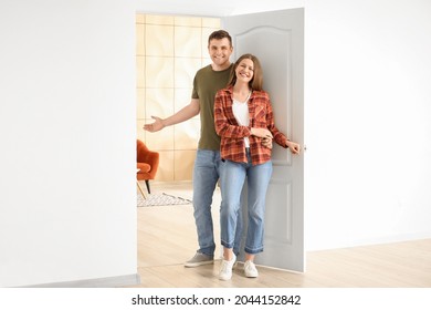 Happy Couple Inviting Guest At Their New Home