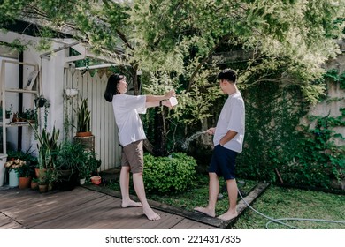 Happy Couple Joking In The Garden House