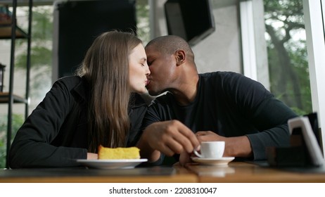 Happy Couple Kissing Dating At Coffee Shop. Diversity Concept Of Two People Kiss. Woman Leaning Head On Boyfriend Shoulder Showing Love And Affection