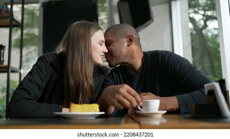 Happy Couple Kissing Dating At Coffee Shop. Diversity Concept Of Two People Kiss. Woman Leaning Head On Boyfriend Shoulder Showing Love And Affection