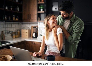 Happy couple in the kitchen, holding hands enjoying in their new renovated modern kitchen - Powered by Shutterstock