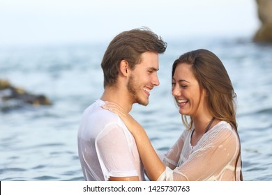 Happy couple laughing bathing on the beach on summer vacation - Shutterstock ID 1425730763