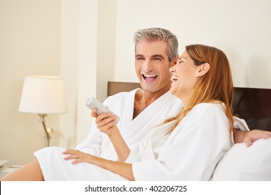 Happy Couple Laughing During Holiday Stay In Hotel Room