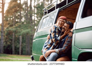 Happy couple laughing and having fun while camping in nature during autumn. Copy space. - Powered by Shutterstock