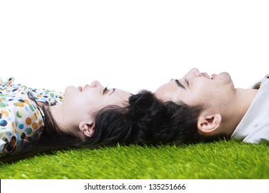 Happy Couple Laying On The Ground With Heads Together