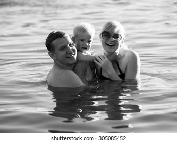 Happy Couple With Little Son Swiming In The River