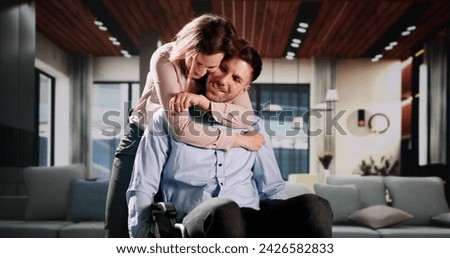 Happy Couple In Living Room. Man In Wheelchair
