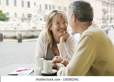 Happy couple looking at each other at outdoor cafe in Rome - Powered by Shutterstock