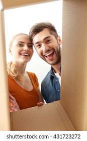 Happy Couple Looking Inside Of Box