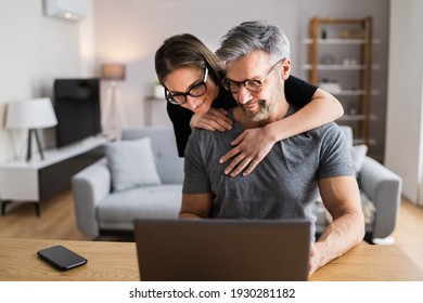 Happy Couple Looking At Laptop. Online Shopping