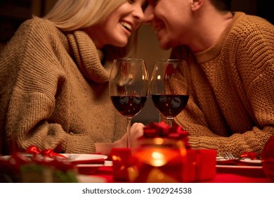 Happy Couple In Love Celebrate Valentines Day Dining At Home, In Restaurant, Having Date With Candles, Red Wine In Glasses Sit At Romantic Setting Table, Close Up View. Valentines Day On February 14