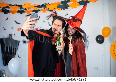 happy couple of love  in costumes and makeup on a celebration of Halloween