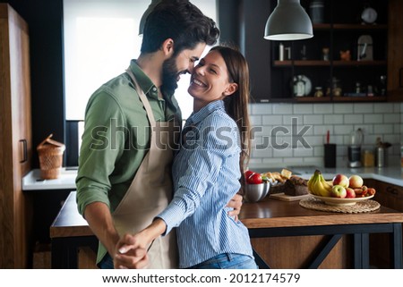 Happy couple in love having fun in kitchen at home