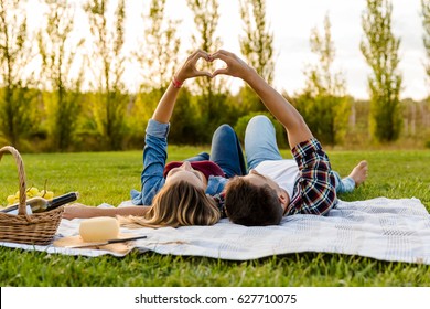 Happy couple in love, lying on the park and enjoying the day together - Powered by Shutterstock