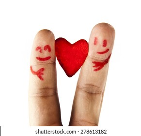 A happy couple in love with painted smiley and hugging One red heart between two fingers in the form of lovely people face with hands hold sign of peace and friendship Symbol Valentin's Day 