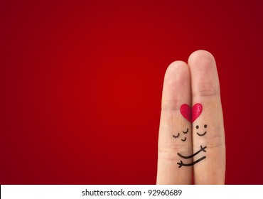 A happy couple in love with painted smiley and hugging - Shutterstock ID 92960689