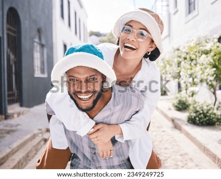Happy couple, love or piggyback portrait in city to travel on romantic date to play a funny outdoor game. Smile, interracial or happy man carrying gen z woman in silly, goofy or playful joke together