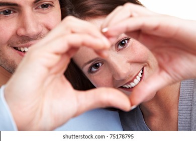 Happy Couple In Love Showing Heart With Their Fingers