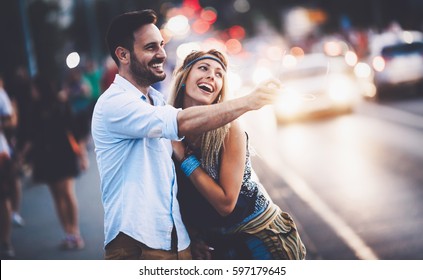 Happy Couple In Love Taking A Walk In City At Night