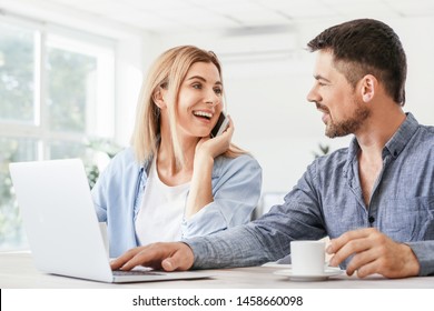 Happy Couple In Love Using Laptop At Home