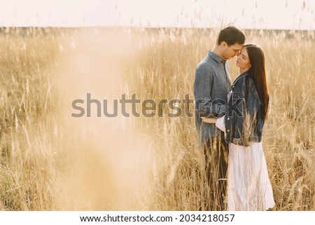 Similar – Image, Stock Photo Couple kissing on the field