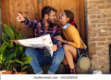 Happy Couple Making Travel Plan.
