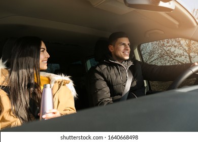 Happy Couple In Modern Car. Family Travel