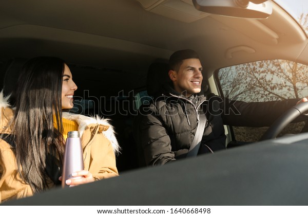 Happy couple in\
modern car. Family travel