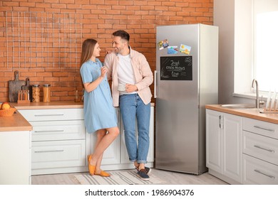 Happy couple near refrigerator in kitchen - Powered by Shutterstock