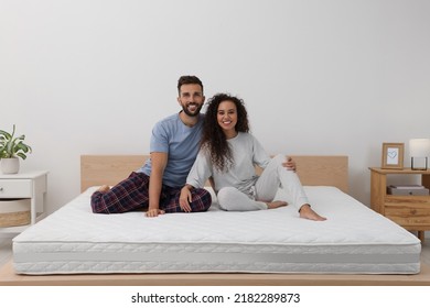 Happy Couple On Bed With Comfortable Mattress At Home