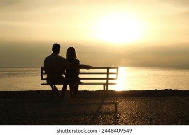 happy couple on a bench by the sea on nature in travel silhouette - Powered by Shutterstock