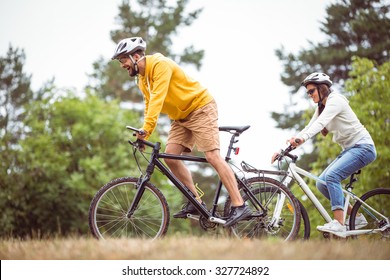 Happy Couple On A Bike Ride In The Countryside