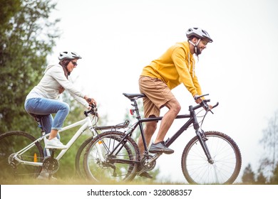 Happy couple on a bike ride in the countryside