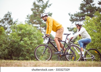 Happy Couple On A Bike Ride In The Countryside