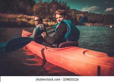 Happy couple on a kayaks