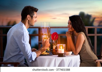 Happy couple on summer evening having romantic dinner outdoor 
