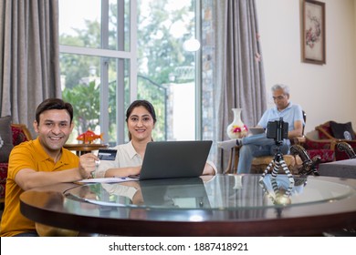 
Happy Couple Online Shopping Using Laptop And Credit Card At Home