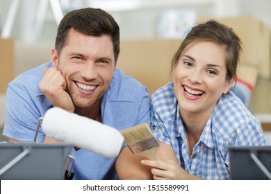 A Happy Couple Painting Their House