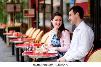 Happy Couple In A Parisian Outdoor Cafe