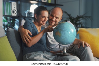 Happy Couple Picking A Destination On The Globe For Their Next Travel